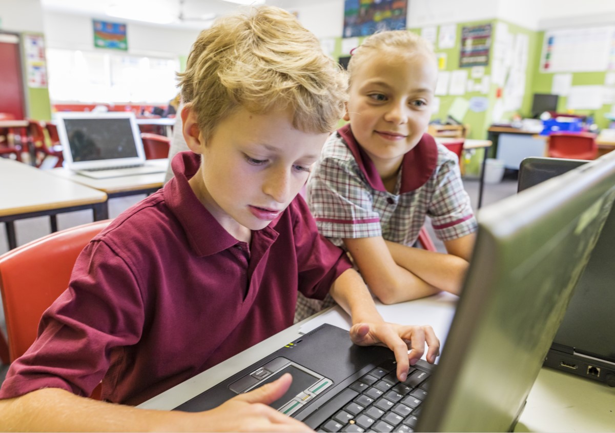 Schulkinder arbeiten mit Laptops