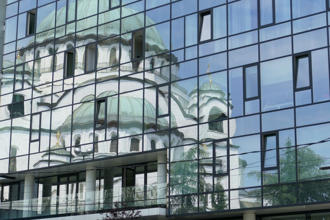 Monument in city of Belgrade through reflection