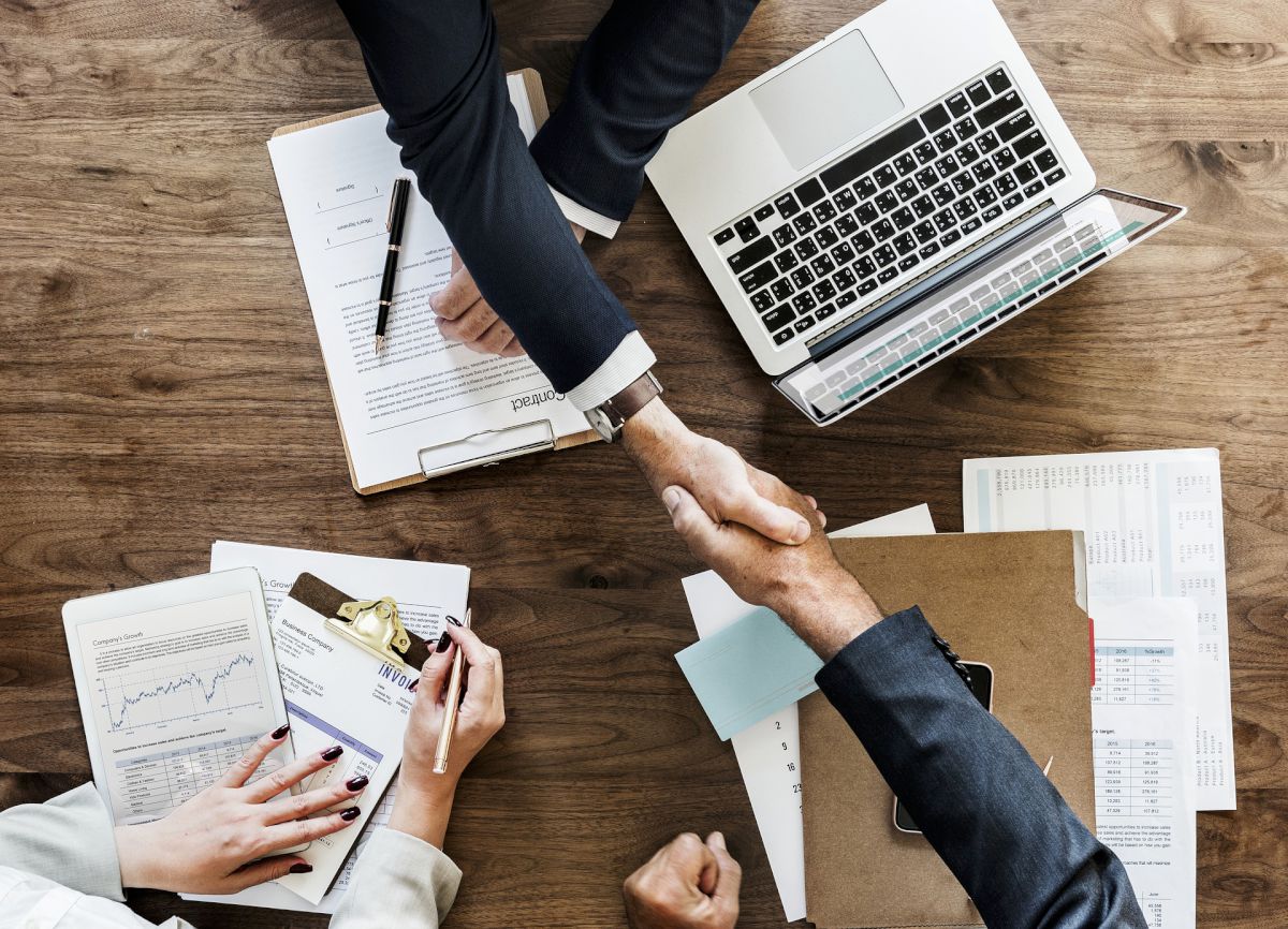 handshake over wooden desk