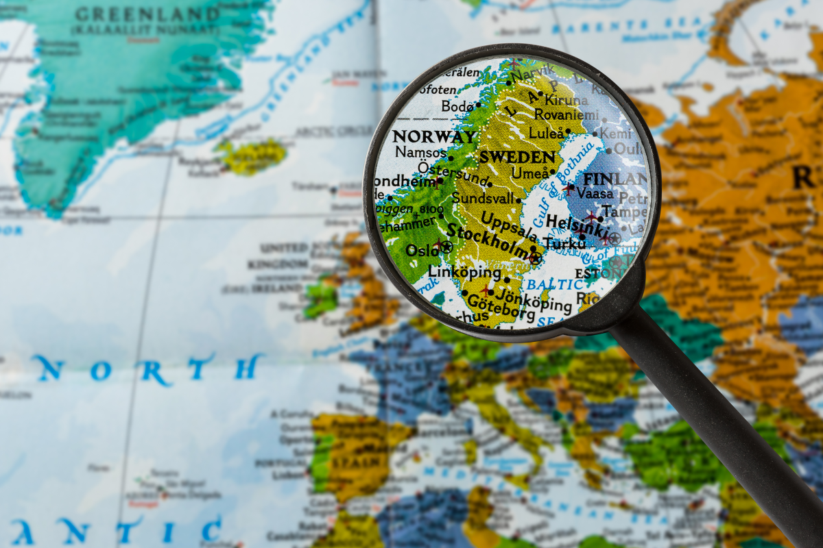 Magnifying glass on a map points to the Nordic countries